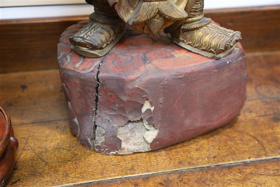 A large Chinese gilt-decorated and polychrome lacquer figure of a temple guardian, 19th century, H.75cm, losses